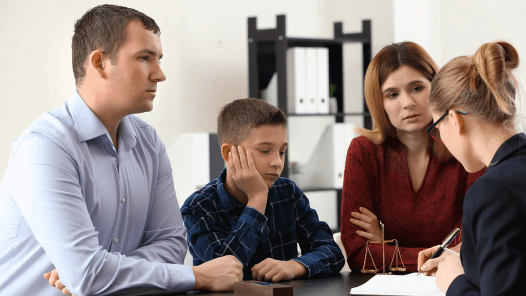 A couple and a child talking to a lawyer.